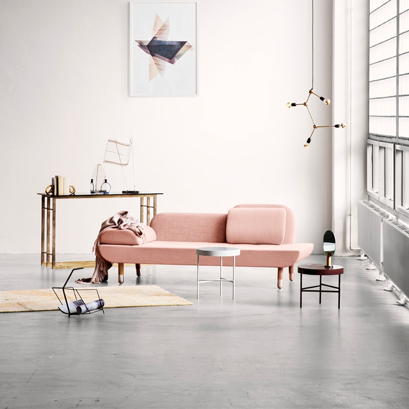 A pink sofa with other furniture