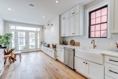 A kitchen with white cabinetry and countertops