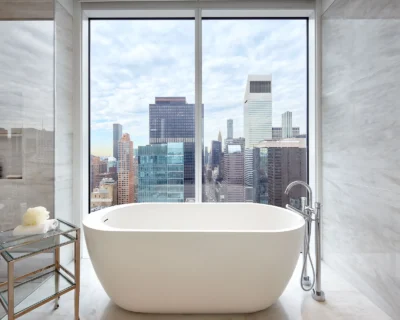 A bathtub next to a large window