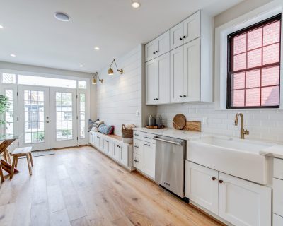 A kitchen with white cabinetry and countertops