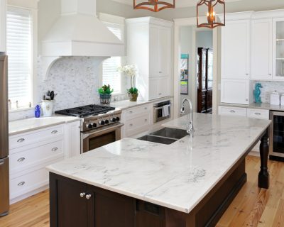 A furnished kitchen with white surfaces